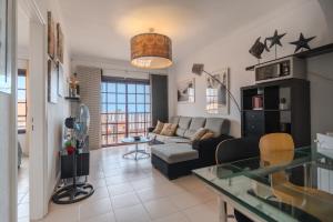 a living room with a couch and a table at Appartment Zomero, SEAVIEW & WIFI & POOL in Costa Del Silencio