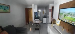 a living room with a flat screen tv on a wall at Impérium residence clube in João Pessoa