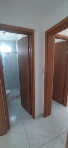 a bathroom with a shower and a toilet and a door at Impérium residence clube in João Pessoa