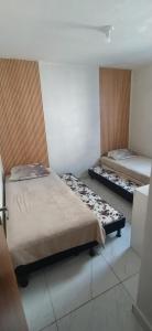 a bedroom with two beds in a room at Impérium residence clube in João Pessoa +1 photo