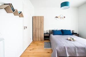 a bedroom with a bed with a dog laying on it at A21 Rhine view condo by the 3-countries-bridge in Huningue