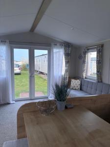 a living room with a couch and a table at Tigh na Mara in Padstow