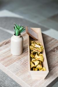 a wooden tray with a box of tofu and a plant at A21 Rhine view condo by the 3-countries-bridge in Huningue