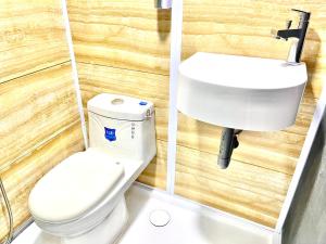 a bathroom with a toilet and a sink at Caca Kabin in Mersing +15 photos
