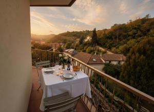 a white table on a balcony with a view at Canelli Wine Suites - Moscato & Barbera in Canelli