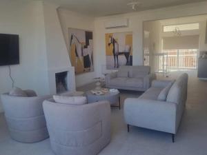a living room with couches and a horse on the wall at Karyatis Building in Nicosia +2 photos