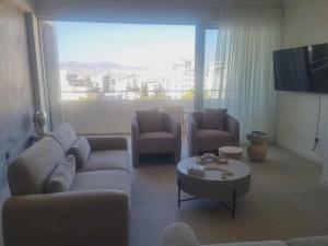 a living room with a couch and chairs and a table at Karyatis Building in Nicosia