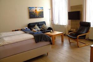 a living room with a couch and a chair at Haus Nordmeer in Borkum