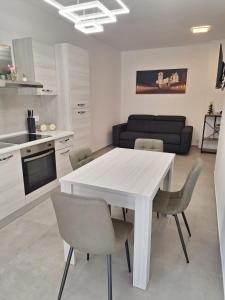 a kitchen and dining room with a white table and chairs at Il Nido a Due Passi da Assisi in Bastia Umbra