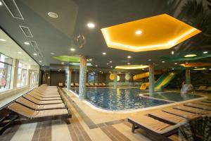 a pool in a hotel with a water slide at Studio Kruna Kopaonik in Kopaonik