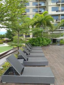 a row of benches in front of a building at Cozy & Spacious 1 Bedroom in the Heart of the City in Cebu City +11 photos