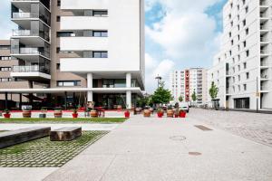 a large white building with a courtyard in front of it at A26 Condo by the Rhine and 3-countries-bridge in Huningue