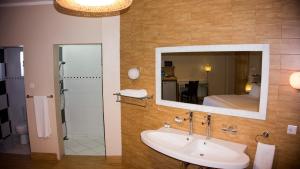 a bathroom with a sink and a mirror at Tropical Enclave Hotel in Accra +37 photos