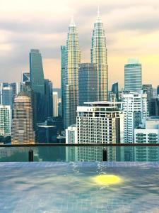 a view of the city from the infinity pool at The Colony Infinity By Castel in Kuala Lumpur
