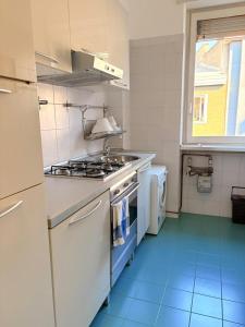 une cuisine avec une cuisinière et un évier dans l'établissement Luxury Home on Corso Garibaldi, à Milan