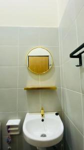 a bathroom with a white sink and a mirror at Prima Lodge Homestay in Kulim +14 photos