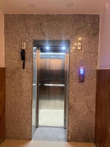 a hallway with a elevator in a building at Hotel Kandara in Pokhara