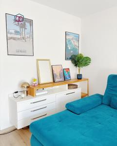 a living room with a blue couch and a table at Le cocon Familial - Appartement Kids friendly proche de la gare in Strasbourg