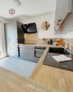 a kitchen with a sink and a counter top at Le cocon Familial - Appartement Kids friendly proche de la gare in Strasbourg