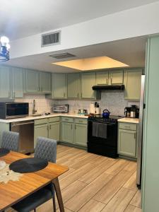 a kitchen with green cabinets and a table and a table and chairs at Msg for 5off 3Bed2Bath KingKingQueenBeds N PHX in Phoenix +26 photos