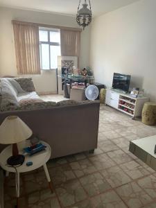 a living room with a couch and a table at QUARTO em casa de FAMILIA in Recife +15 photos