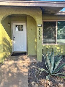 a plant in front of a house with a door at Msg for 5off 3Bed2Bath KingKingQueenBeds N PHX in Phoenix