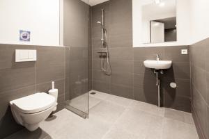 a bathroom with a toilet and a sink and a shower at Hotel Not Hotel Amsterdam in Amsterdam +26 photos