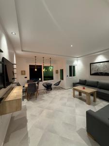 a living room with a couch and a table at Martil appartement avec vue sur mer in Martil