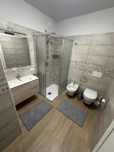 a bathroom with a shower and a toilet and a sink at La casa di Amelie in Flero