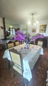 a table with a vase of purple flowers on it at Casa Rural La Chaparra - Apartamento Fondales in Pitres +9 photos