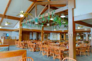 a dining room with tables and chairs in a building at Roaring River State Park in Cassville