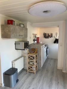 a small kitchen with a sink and a microwave at Ferienhaus Seeruhe in Flessenow