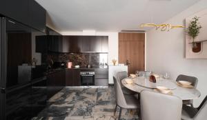 a kitchen with a table and chairs in a kitchen at Ruby Luxurry Apartment - LUMIERE Riverside in Ho Chi Minh City