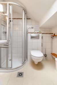 a white bathroom with a shower and a toilet at Ferienwohnung Alpenpanorama in Oberau +31 photos