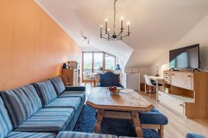 a living room with a couch and a table at Ferienwohnung Alpenpanorama in Oberau