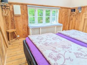 a bedroom with two beds and a window at Stevns Birkevang The Silo - Rural refuge in Faxe