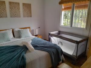 a bedroom with a bed with a towel on it at El Higuerón (Serranía de Ronda) in Jimera de Líbar