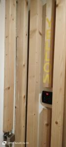 a wooden wall with a remote control on it at Pink Yellow Porto Apart in Porto