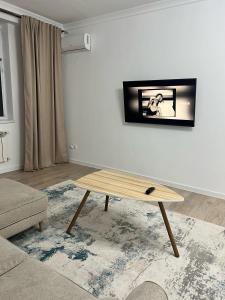 a living room with a coffee table in front of a wall at ЖК Green Plaza Aktau Двухкомнатная большая in Aktau