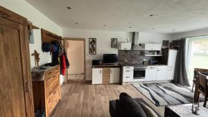 a kitchen with white cabinets and a stove top oven at Smaragdherz in Bramberg am Wildkogel
