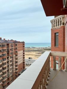 a balcony with a view of the beach and buildings at ЖК Green Plaza Aktau Двухкомнатная большая in Aktau