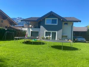 a person playing on two ping pong tables in a yard at Smaragdherz in Bramberg am Wildkogel