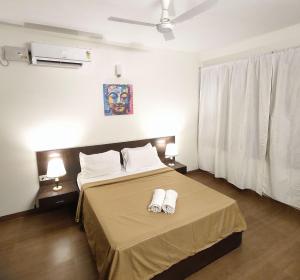 a bedroom with a bed with two towels on it at The Four Corners-1BHK Palolem Garden Estate Near Palolem Beach in Canacona