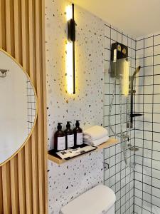 a bathroom with a toilet and some bottles on a shelf at Yukata Space 