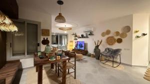 a living room with a table and a couch at Cozy 2BRs chalet in Einbay Boho designed in Ain Sokhna
