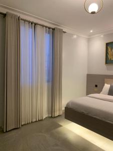Ένα ή περισσότερα κρεβάτια σε δωμάτιο στο Hoxton Suites