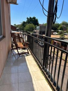 a bench sitting on the side of a balcony at Departamento Centrico Iguazu 2A in Puerto Iguazú