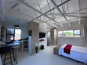a bedroom with a bed and a desk and a sink at Quilla Quarters in Plumstead
