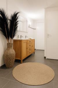 a bathroom with a sink and a vase with a plant at Zenda's natuurhuisje in Lanaken