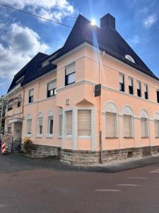 a large brick building with a black roof at Loftwohnung Happy Holiday in Herschbach